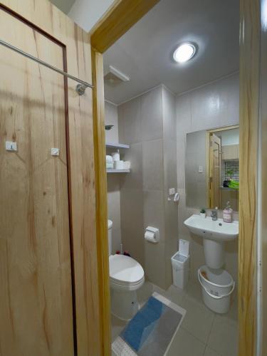 a bathroom with a toilet and a sink at Inspiria Condo Units beside Abreeza Mall Davao in Davao City