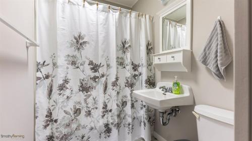a bathroom with a shower curtain and a sink at 204 E Syracuse Ave in Wildwood Crest