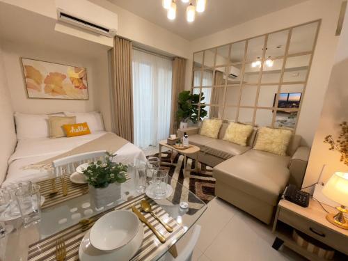 a bedroom with a bed and a living room at Inspiria Condo Units beside Abreeza Mall Davao in Davao City