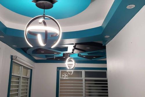 a blue and white ceiling with a chandelier at RH/Los angeles (#1) front of airport in San Juan