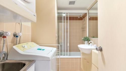 a bathroom with a sink and a shower at Beachside Woorim Weekender in Woorim