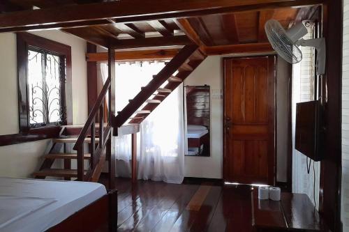 a room with a staircase and a room with a door at Panawan Cinco in General Luna