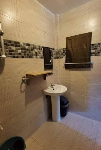 a bathroom with a sink and a mirror at Panawan Cinco in General Luna