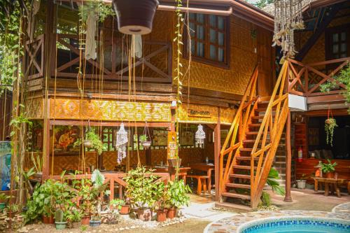 a building with a staircase and a patio with plants at Natura Vista in Panglao