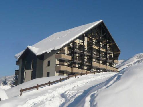 un bâtiment au sommet d'une montagne enneigée dans l'établissement Charmant Appartement avec Balcon à Villard-de-Lans, Proche Centre et Pistes - FR-1-515-164, à Villard-de-Lans