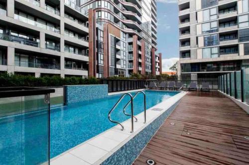a swimming pool in the middle of some buildings at Moonee Ponds Stylish Apartment - 415 in Melbourne