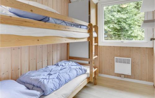 a bunk bed room with two bunk beds and a window at Viscum in Arnager