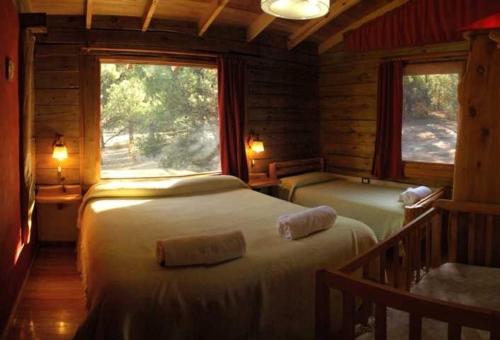 Кровать или кровати в номере Cabañas Bosques del Sol