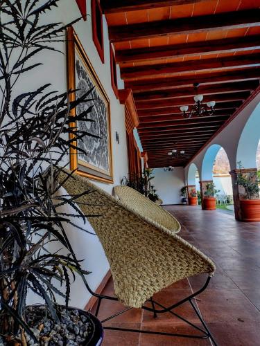 a room with a chair and a potted plant at Palacio Del Cobre in Tepoztlán