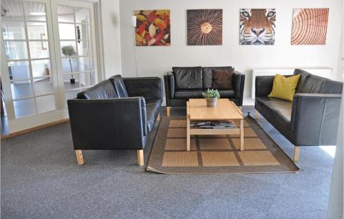 a living room with two couches and a coffee table at Holiday Home Rypevej Nordborg X in Nordborg
