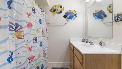 a bathroom with a shower curtain with fish on it at 509 E 15th Ave, Unit F in North Wildwood