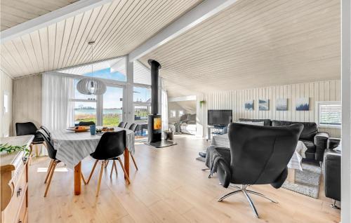 a living room with a table and chairs and a fireplace at Lovely Home In Kerteminde With Wifi in Kerteminde