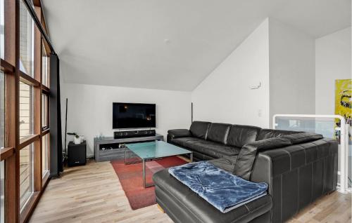 a living room with a couch and a table at Amazing Home In Egernsund With Sauna in Egernsund