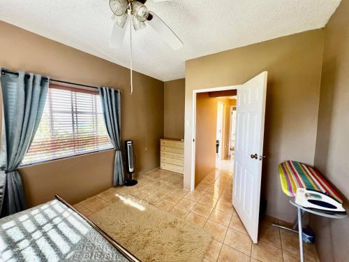 a bedroom with a bed and a ceiling fan at 2 Bed Apartment at the Hideaway in St Mary