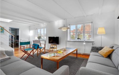 a living room with a couch and a table at 4 Bedroom Awesome Home In Glesborg in Glesborg
