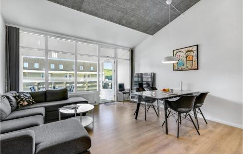 a living room with a couch and a table at Gorgeous Apartment In Ringkøbing in Ringkøbing