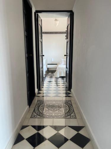 a hallway with a black and white tiled floor at 704 vista casco antiguo y nuevo in Cartagena de Indias