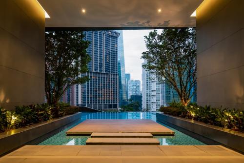 einen Pool mit Blick auf die Skyline der Stadt in der Unterkunft 8 Kia Peng Residences by Times 8 in Kuala Lumpur