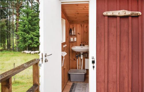 a bathroom with a sink next to a red barn at 2 Bedroom Nice Home In Nssj in Nässjö