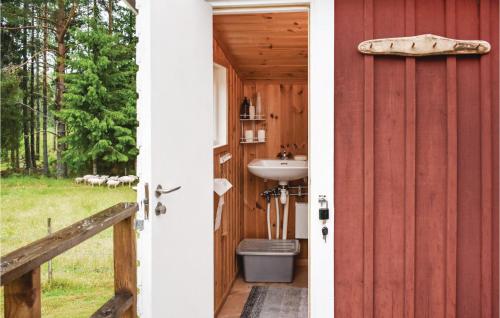 a bathroom with a sink next to a red barn at Two-Bedroom Holiday Home In Nassjo in Nässjö