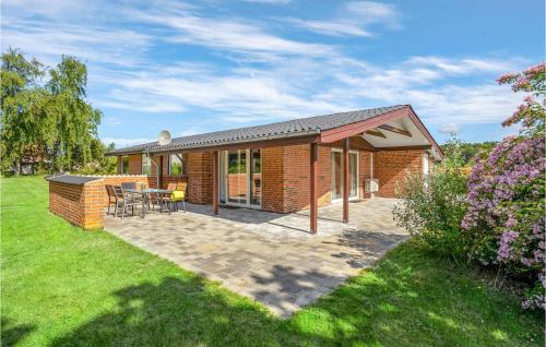 una casa in mattoni con patio in un cortile di Holiday Home Hvidkløvervej Ebeltoft a Ebeltoft