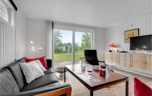 a living room with a couch and a table at Stunning Home In Assens With Kitchen in Assens