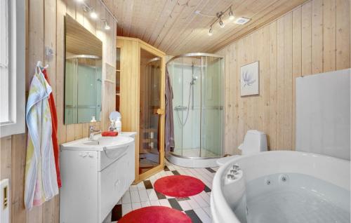 a bathroom with a tub and a sink and a shower at Stunning Home In Assens With Kitchen in Assens