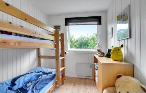 a small bedroom with a bunk bed and a desk at Stunning Home In Assens With Kitchen in Assens