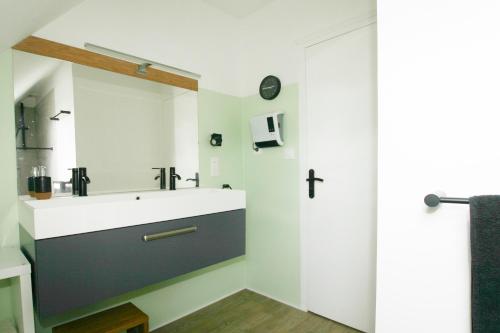 a bathroom with a sink and a shower at La " Villa " du JET in Ergué-Gabéric