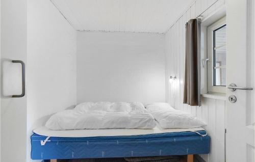 a bed sitting on a blue platform in a room at Holiday Home Vester Storetoft Fanø I in Sønderho