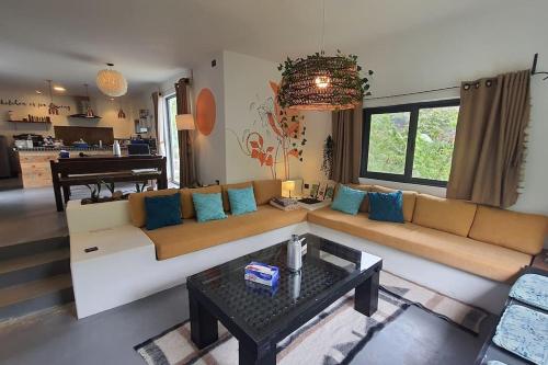 a living room with a couch and a piano at Bali Villa Pokhara in Pokhara