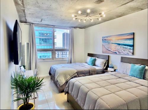 een slaapkamer met 2 bedden en een raam bij Platinum 2BD 2BTH at Midblock in Miami