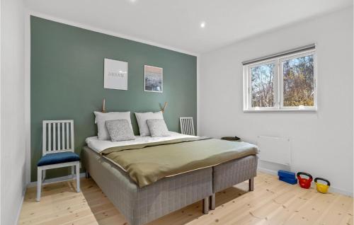 um quarto com uma cama grande e uma cadeira azul em Lovely Home In Stege With Wifi em Stege