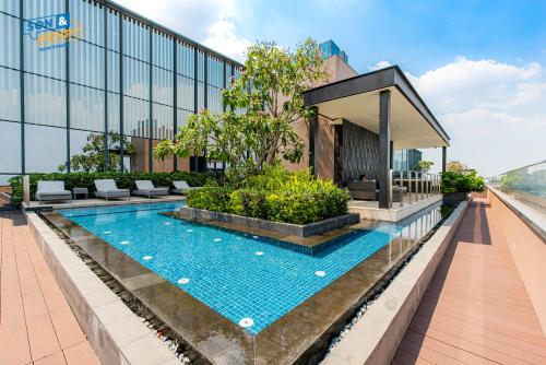 a swimming pool in front of a building at Son&Henry The MarQ Luxury in Ho Chi Minh City
