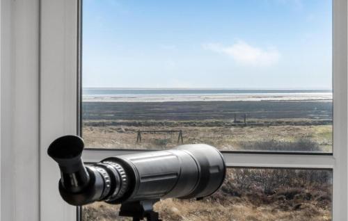 a view of the ocean from a window with a camera at 3 Bedroom Lovely Home In Rømø in Havneby