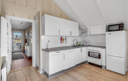 a kitchen with white cabinets and white appliances at 3 Bedroom Lovely Home In Rømø in Havneby