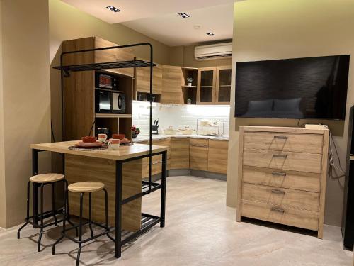 a kitchen with a island with stools and a counter at Choska Residence in Jakarta