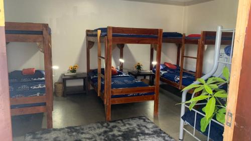 a room with three bunk beds in a room at Soul Travellers Dagatan Castle in Badian