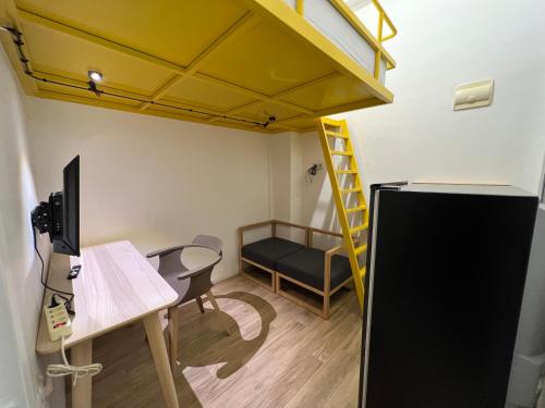 a room with a desk and a loft bed at Choska Residence in Jakarta