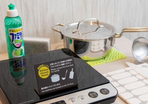 a sign on top of a counter next to a stove at Tokyu Stay Sapporo Odori in Sapporo