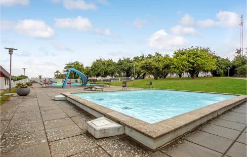a swimming pool in a park with a playground at 2 Bedroom Nice Apartment In Allinge in Allinge