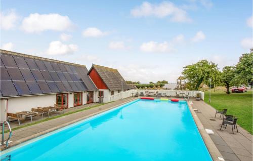 an image of a swimming pool in front of a house at 2 Bedroom Nice Apartment In Allinge in Allinge