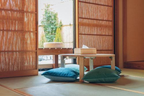 a room with a table and two pillows and a table at Skytree Tatami Hotel in Tokyo