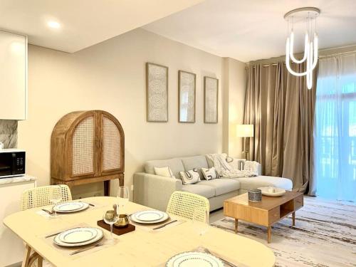 a living room with a couch and a table at Dar Vacation - Modern Luxury 1BR Apartment in MJL in Dubai