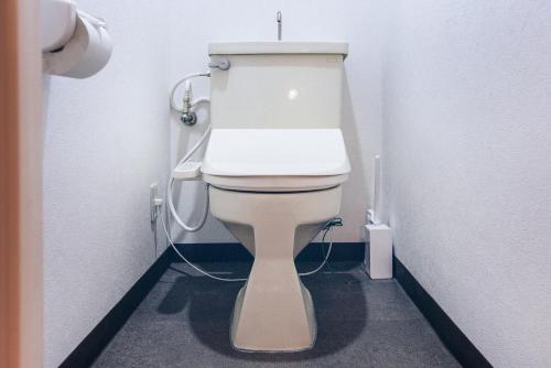 a bathroom with a white toilet in a stall at Nippori Fabric Hotel in Tokyo