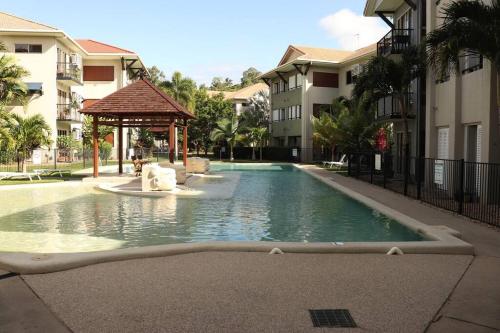 a swimming pool with a gazebo next to some buildings at Clifton Beach Retreat - 2 bed 2 bath apartment in Clifton Beach