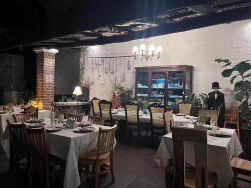 uma sala de jantar com mesas e cadeiras e um empregado de mesa em Casa Degraciela - Hotel Boutique em Concepción de Ataco