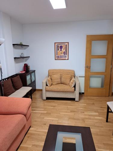 a living room with a couch and a door at APARTAMENTO GUIMAREY in Sanxenxo