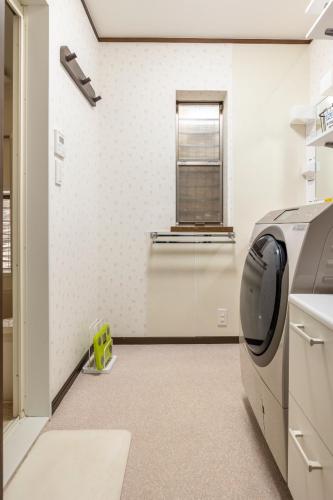 a kitchen with a washing machine in a room at Dat's house in Tokyo