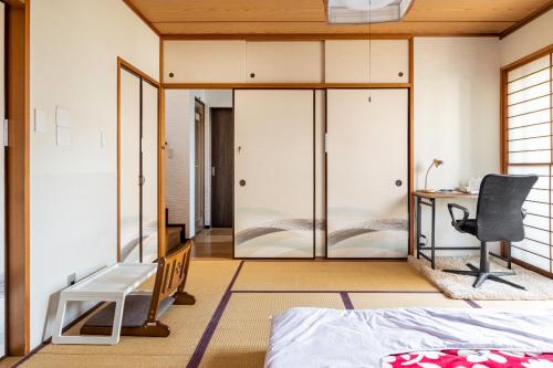a bedroom with a desk and a chair at Dat's house in Tokyo